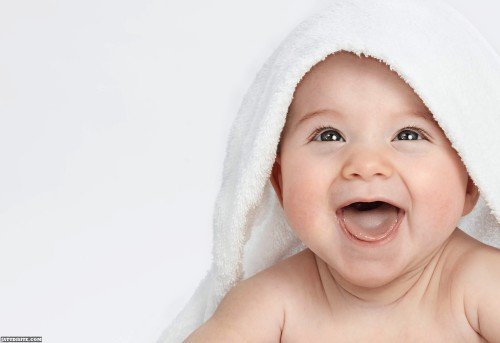 Smilling Baby Under White Towel