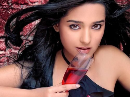 Amrita Holding A Glass Of Wine