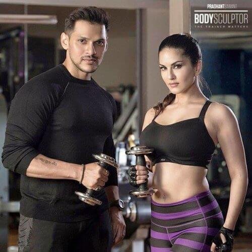 Sunny Leone With His Trainer In Gym